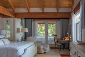 White-on-white textures and a comfy king-size bed make the main bedroom a relaxing retreat, while an office nook, with a desk, chair and ottoman all from Universal Furnishings gives the owners a tidy spot to catch up on work if needed.