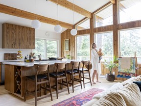 Allison Weldon, founder and owner of Sangre de Fruta Botanical, poses with baby Rocco in her family's recently renovated home on Bowen Island.