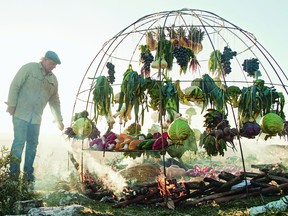 Argentinian chef Francis Mallmann, author of Green Fire (Appetite by Random House), with the iron dome he built to grill fruit and vegetables over a fire pit.