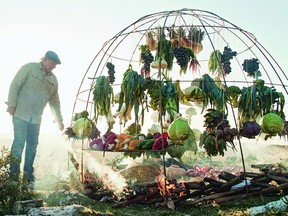 Argentine chef Francis Mallmann, author of Green Fire (Random House's Appetite), with the iron dome he built to roast fruit and vegetables over a fire.