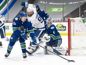Guillaume Brisebois (left) has signed another two-way contract with the Canucks, the only NHL franchise he has ever played for.