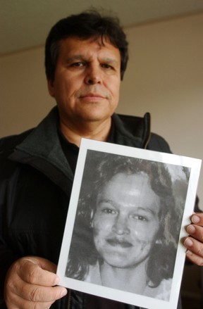 Ernie Crey holds a photo of his sister, Dawn Crey