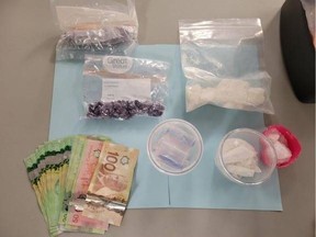 Surrey RCMP say it found drugs, cash and a handgun after stopping a stolen vehicle. Three people were arrested.