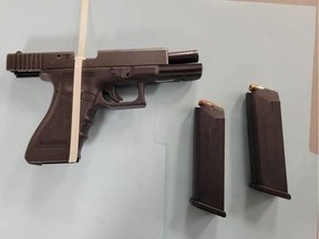 Photo of a handgun with two loaded magazines Surrey RCMP seized from a stolen vehicle.