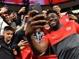 Canada's midfielder Alphonso Davies (R) signs autographs and takes photos with fans following the Concacaf Nations League football match between Canada and Curacao at BC Place last week. Local fans might just get to see him again in 2026 — this time, playing a World Cup game in the same stadium.