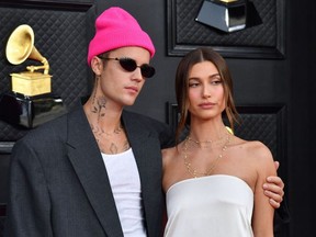 Canadian performer Justin Bieber (L) and his wife, model Hailey Bieber, are pictured as they arrive for the 64th Annual Grammy Awards at the MGM Grand Garden Arena in Las Vegas on April 3, 2022.