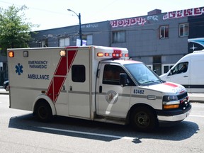 An ambulance, lights flashing, at work during the extreme hot weather in Vancouver in late June of 2021.
