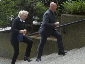 Lt. Erik Verstraten of the Dutch National Police (right) ascends the stairs at the New Westminster Supreme Court with an unidentified woman after a lunch break on June 13, 2022.