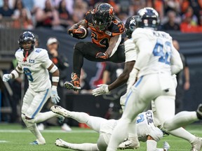BC Lions' James Butler jumps over the tackle of Toronto Argonauts' Royce Metchie during first half of CFL football action in Vancouver, B.C., Saturday, June 25, 2022.