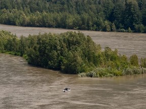 Sport fishermen are seen on a boat on the high and fast moving Fraser River, between Hope and Agassiz, B.C., on Monday, July 6, 2020.