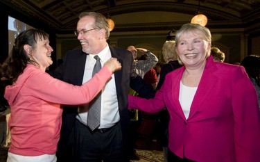 John Horgan gets a hug from a well wisher after winning Juan de Fuca and beside him on the right is reelected for Esquimalt Maurine Karagianis at the Fairmont Empress  in Victoria, B.C. May  12, 2009.