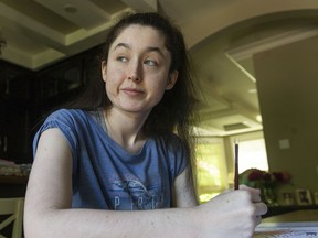 Sophie Cowin works on a painting at her family home in Vancouver. Sophie had a device implanted that monitors her brain for signs of seizures coming on. The frequency of her seizures, which she has suffered since she was eight, has decreased since her operation.  
(Photo by Jason Payne/ PNG)