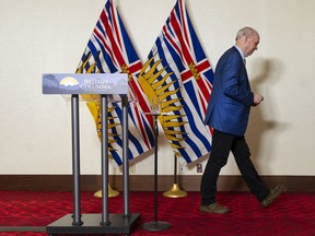 B.C. Premier John Horgan leaves a press conference where he announced that he will not be seeking re-election and that he is stepping down as party leader pending a leadership race.