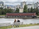 A barge sits stranded on the shore near Sunset Beach in Vancouver on Wednesday, June 29, 2022. The barge has become a fixture and point-of-interest to local and tourists alike since being washed ashore during a storm in late 2021. 