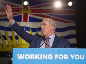 B.C. NDP Leader John Horgan waves to the crowd at NDP headquarters in Vancouver on May, 10, 2017.