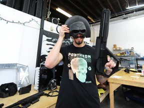 Pantheon Design's Logan Nimmo models a pair of 3D-printed props the Vancouver company produced for the television show Peacemaker (helmet) and the movie The Adam Project (gun).