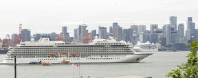 Smaller boats prepare to escort passengers of the Viking Orion as it sits at anchor in Burrard Inlet. The Canada Place cruise ship terminal (background) was at capacity on Sunday.