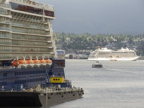 Three cruise ships were docked at Canada Place, left, a full house, leaving one ship, anchored in Burrard Inlet, its passengers ferried to terminal using small boats.