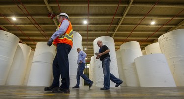 From left: GM Mark Evans, CEO Dino Bianco and reporter Gordon McIntyre during a tour of Kruger Products LP in New Westminster on June 16, 2022.