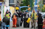 Sanitation workers clean sidewalks in the Downtown Eastside on June 19, 2022. These city workers are different from the 