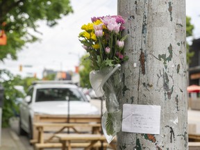 Flowers and a note are attached to a pole on June 20, 2022, after a hit and run at Arbutus and West Fourth Avenue left one person dead.