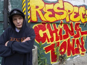 Downtown Eastside artist Smokey D by his mural in Chinatown.