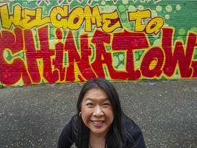 Lorraine Lowe, executive director of Dr. Sun Yat-Sen Classical Chinese Garden, by a Chinatown mural painted by Downtown Eastside street artist Trey Helten.