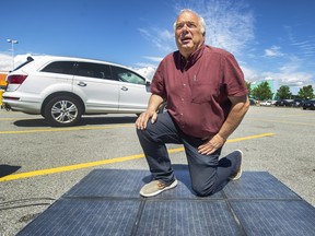 VANCOUVER, BC – June 23, 2022 – Jan Polderman, mayor of Lytton, with sidewalk solar tiles in Richmond, BC., June 23, 2022. He is planning to install them in Lytton. Arlen Redekop / PostMedia staff photo.