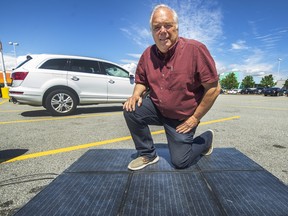 VANCOUVER, BC - June 23, 2022 - Jan Polderman, mayor of Lytton, with sidewalk solar tiles in Richmond, BC., June 23, 2022. He is planning to install them in Lytton. Photo: Arlen Redekop/Postmedia.