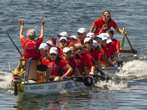 People participate in and watch the Dragon Boat races in False Creek in Vancouver, BC., June 26, 2022.