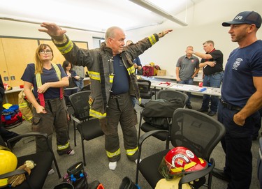 B.C. Premier John Horgan goes through a mini training session as part of the B.C. Professional Firefighters Fire Ops program at the Vancouver Training Center in Vancouver, B.C., Sept. 25, 2017.