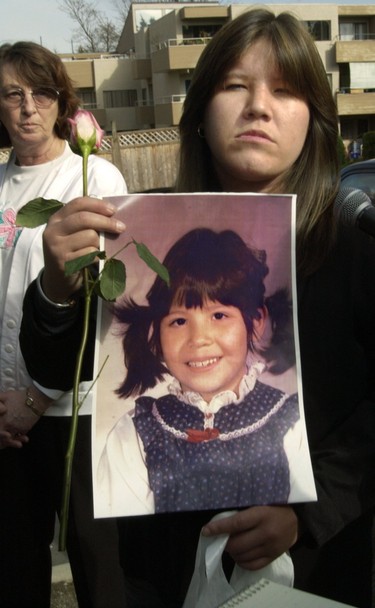 Ada Wilson holds up a photo of her sister Mona Wilson following a memorial service for Mona held at St. John the Devine Church. Mona, one of the missing women, was five years old when the photo was taken. Mona is one of the six women that Robert Pickton was convicted of killing.