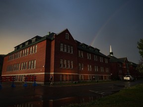 A rainbow is seen above the former Kamloops Indian Residential School after a day-long ceremony to mark the one-year anniversary of the Tk'emlups te Secwepemc announcement that 215 suspected unmarked graves had been detected at the former residential school, in Kamloops, B.C., on Monday, May 23, 2022.