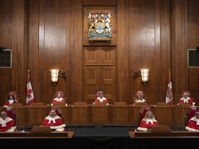 Justices of the Supreme Court pose for a photo sitting in the Supreme Court following a welcoming ceremony, October 28, 2021 in Ottawa.
