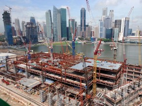 Highrises create more carbon emissions than lowrises in part because "to build tall you need heavier structures, chunkier concrete foundations," says Francesco Pomponi, of Edinburgh Napier University, who has produced an original study on the subject. Pictured here, Singapor construction with a backdrop of highrises.