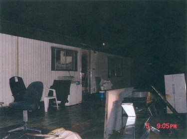 A photo entered in to evidence in the murder trial of Robert William Pickton in Port Coquitlam: The exterior of Pickton's messy trailer, which had old chairs and appliances sitting on a deck outside the main door. The Crown says police found four asthma inhalers and Revenue Canada documents made out to Sereena Abotsway, one of the women Pickton is accused of killing, in a garbage can outside his bedroom window.