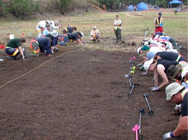 Searchers, including police officers and students of anthropology and archeology, conduct a systematic hand search in 2003, looking for evidence in the Jane Doe case in a rural area near Mission. The unidentified missing woman's partial skull was found at this site in 1995, and her heel and rib bones were found in 2002 on the farm of convicted serial killer Robert (Willie) Pickton.