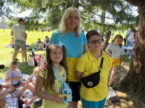 Olha Borshchevska and her daughter Yana (left) and son Oleksii (right) are recent arrivals from Ukraine who were welcomed at a picnic on June 25, 2022.