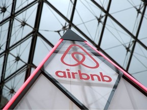 The Airbnb logo is seen on a small mini pyramid under the glass pyramid of the Louvre Museum in Paris, France, March 12, 2019.