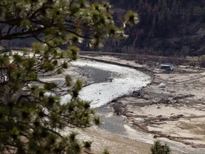 A home on the Nicola River that was affected by flooding in November, sits on mud covered farmland west of Merritt, B.C., on Wednesday, March 23, 2022. The River Forecast Centre says rising levels in some waterways of British Columbia's southeastern Interior could ease as runoff from recent heavy rains decreases, but downpours continue to swell rivers and streams in north and central parts of the province.