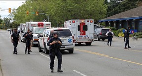 Police and paramedics respond to a bank robbery at the Bank of Montreal at Shelbourne and Pear streets Tuesday where multiple people were injured in a shootout.