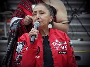Kat Norris speaking outside the Vancouver Art Gallery wearing a jacket given to her by her brother Sam Bob.