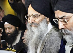 Ripudaman Singh Malik, centre, and son Jaspreet Malik, left, on March 16, 2005