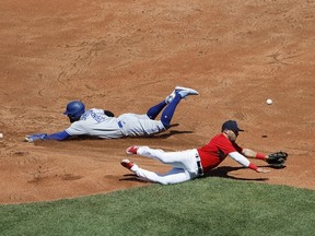George Springer of the Blue Jays safely steals second base as the throw gets past Yolmer Sanchez of the Red Sox during the second inning at Fenway Park on July 24, 2022 in Boston.