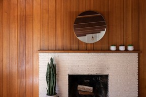 The fireplace and wood-paneled walls of the Brooks home in the Delbrook neighborhood of North Vancouver.
