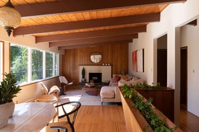 The open living space of the Brooks' house, where there is no separation between the dining and living rooms, and large windows and a deck bring the outside in.