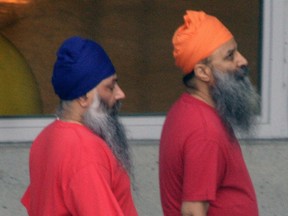 Accused Air India bombers Ajaib Singh Bagri (left) and Ripudaman Singh Malik walk together through the exercise yard at the jail where they are in custody Nov. 1, 2004 in Vancouver, British Columbia, Canada.