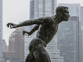 Showers fall on the statue of Harry Jerome at the downtown Vancouver waterfront in a file photo.