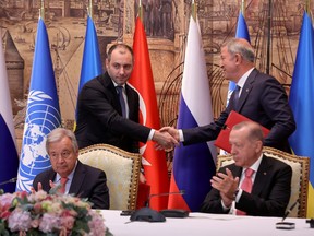 Ukrainian Infrastructure Minister Oleksandr Kubrakov and Turkish Defence Minister Hulusi Akar shake hands next to UN Secretary-General Antonio Guterres and Turkish President Recep Tayyip Erdogan during a signing ceremony in Istanbul, Turkey, July 22, 2022.