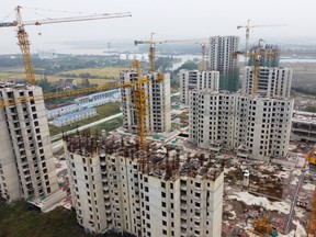 China’s Evergrande, the world’s most indebted real-estate developer, is on the verge of bankruptcy. China’s housing crisis has wiped a trillion dollars off the value of the sector. Combined with other problems, more people from China are looking for a way out. (Photo: Halted construction of a China Evergrande Group project in China, October 22, 2021.)